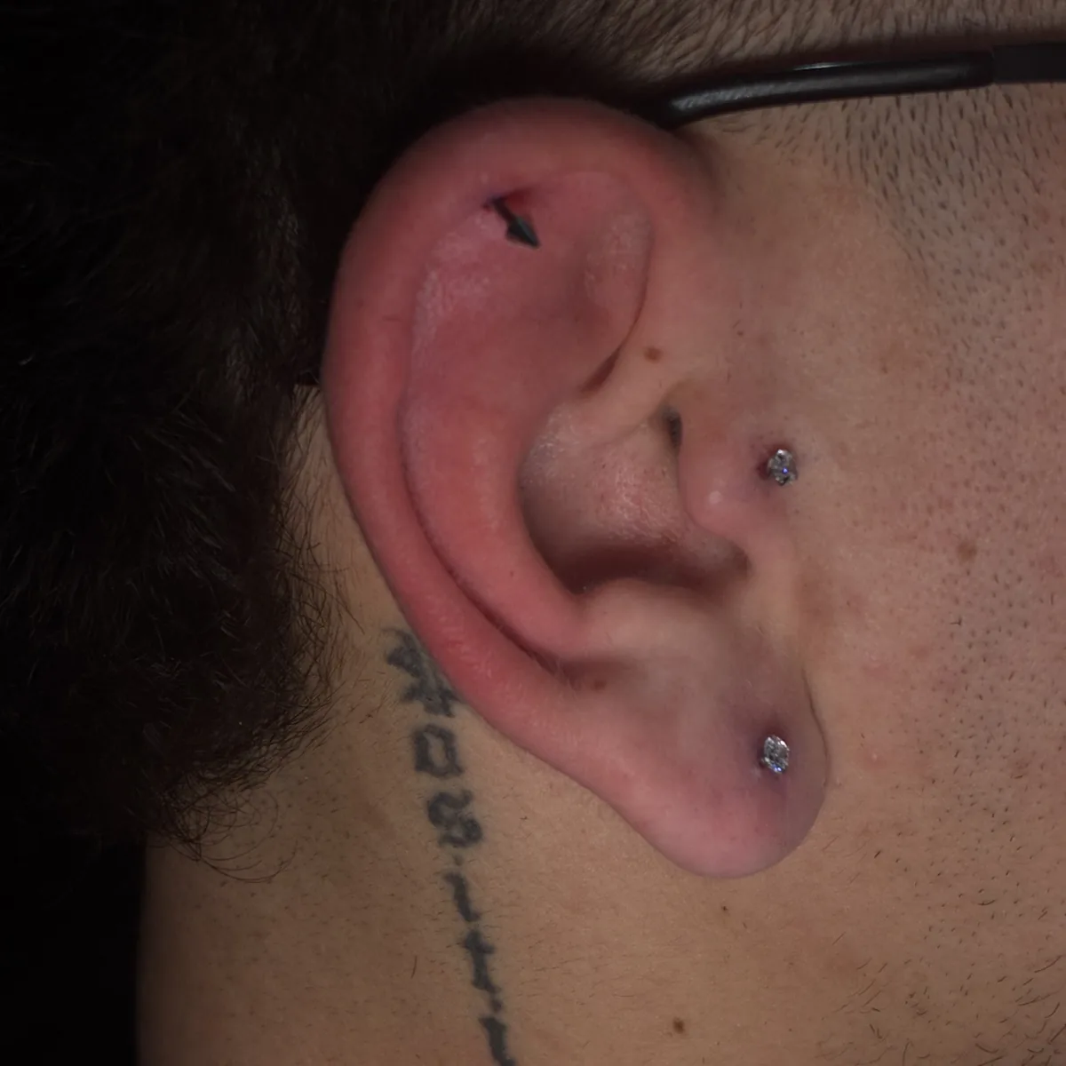 Ear helix and lobe piercings, close-up