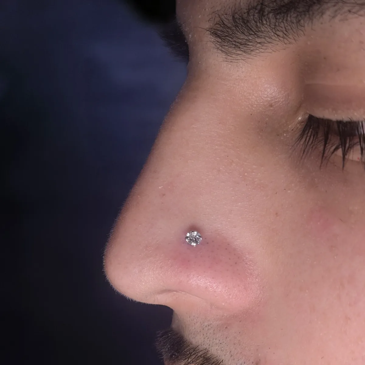 Close-up of a nose piercing with a small stud